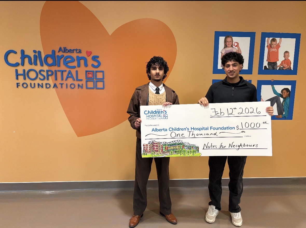 Aarez Muhammad and Praveer Bal presenting a one thousand dollar donation cheque for Alberta Children's Hospital Foundation